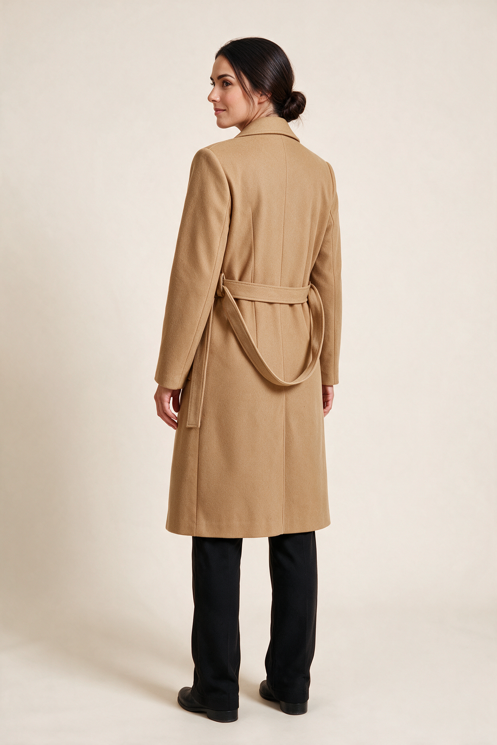 Belted coat with patch pockets — Golden camel, worn by Sofia, rear view looking over her shoulder